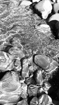 black and white water over rocks