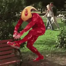 Man in red suit and banana helmet dancing
