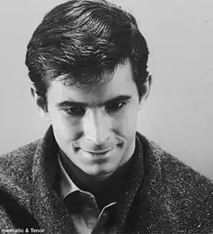 Anthony Perkins smirking