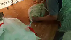 Person kneading large green dough