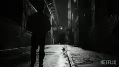 Silhouette walking down dark alley