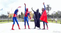Superheroes dancing in costumes