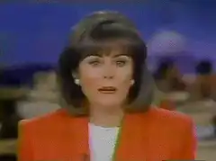 Woman in orange jacket with video calibration glitch