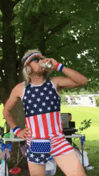 man in flag swimsuit drinking
