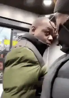 Man in green jacket stares intensely