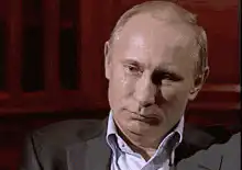 Vladimir Putin laughing and facepalming