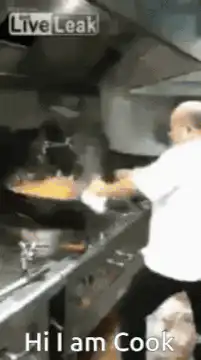 Chef flips food in wok