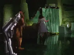 Dorothy pulls back green screen to reveal Wizard