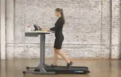 Woman working on treadmill desk