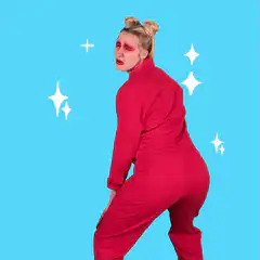 Woman in red jumpsuit dancing with sparkles