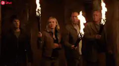 Four people with torches in a treasure room