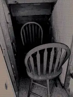 Two chairs in a narrow hallway