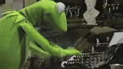 Kermit the Frog typing on a typewriter