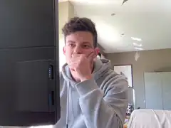 guy covering mouth near computer