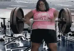 Woman lifting heavy barbell in gym