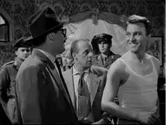 Man in tank top poses for camera