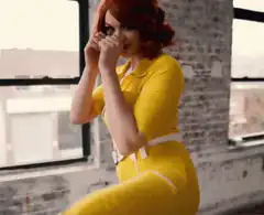 Woman in yellow dress dodging a punch