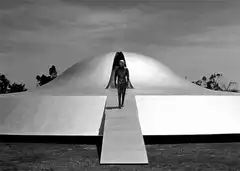 Astronaut walks down ramp from dome