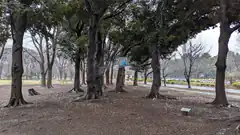 park with trees and blue sign