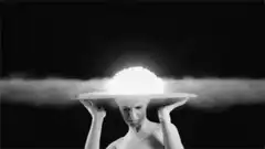 Woman holding glowing mushroom