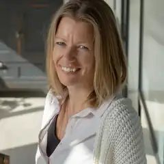 Blonde woman smiling in sunlight