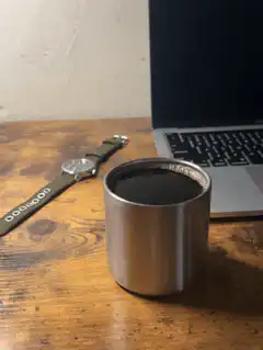 watch and coffee cup on desk