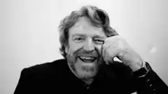 Kenny Rogers smiling with hand on face