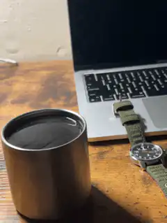 coffee cup and laptop on desk