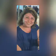 Smiling woman in blue top at party