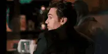 Timothée Chalamet smiling over shoulder