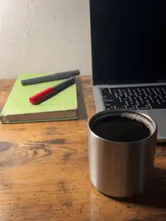 Coffee cup steaming on desk
