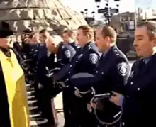 priest salutes police officers