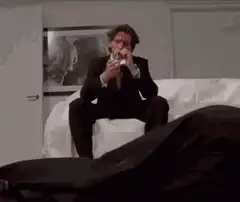 Patrick Bateman smoking on the bed