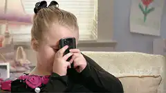 girl holding phone to eye