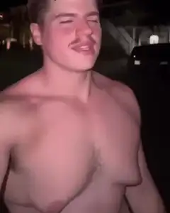 shirtless man with mustache winking