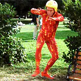 Man in red and yellow suit dancing in park