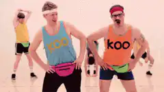 Men in Koo tank tops dancing