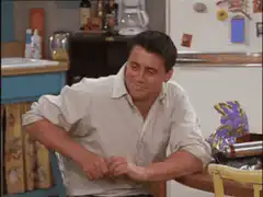 Joey Tribbiani smirking and looking confused