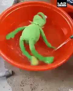 green frog plushie in orange basin
