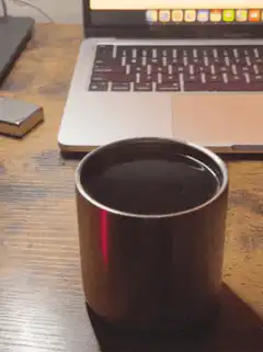 Coffee cup on desk with laptop