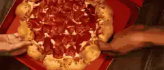 Hands pulling apart a pepperoni pizza