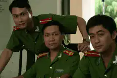 Three men in green uniforms with glowing red eyes