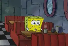 SpongeBob sitting alone at a diner table