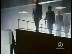 Silhouetted figures on a spaceship balcony