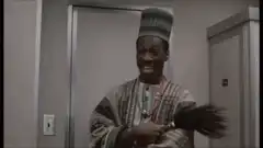 Eddie Murphy as Uncle Eddie with a feather duster