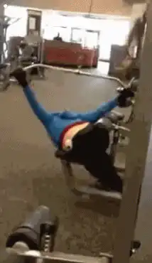 Woman doing pull-ups in gym