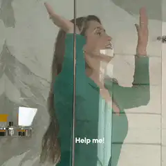 Woman trapped behind glass door