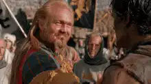 King Richard laughs and kisses a knight