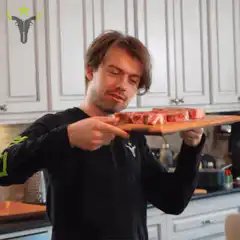 Man holding steak with finger pointing