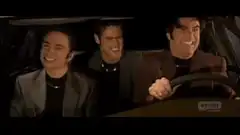 Three men laughing in a car